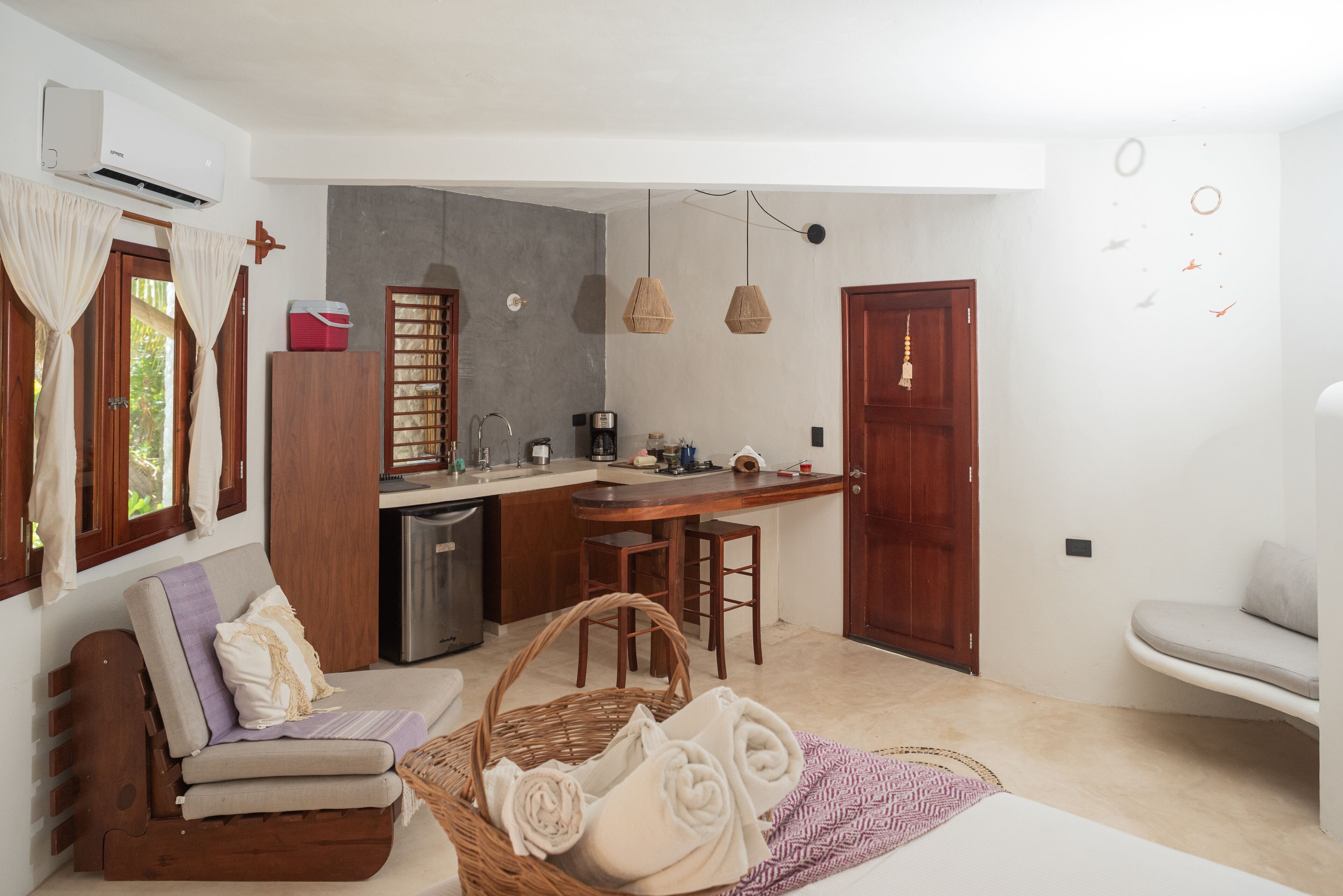 A compact living space with a kitchenette, a dining area, and a seating area.