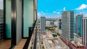 A high-rise building with a modern design, featuring large windows and a view of a cityscape with other high-rise buildings. - Modern Lux Studio in Biscayne Boulevard #4008 (Miami)