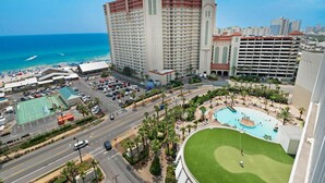 A high-rise hotel with a pool, a tennis court, and a view of the ocean. - Laketown Wharf 1326 (Panama City Beach)