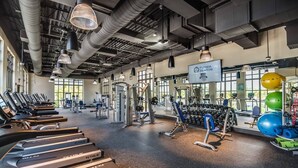 A gym with treadmills, weight machines, and exercise balls. - Solara Resort -  5 bedrooms, Private Pool - FROZEN & HARRY POTTER - DISNEY AREA (Kissimmee)