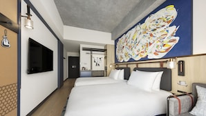 A hotel room with a large bed, a TV mounted on the wall, a painting, and a desk with a chair. - Caption by Hyatt Namba Osaka (Osaka)