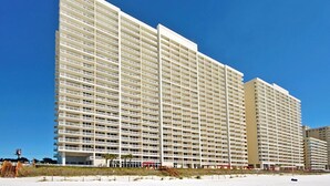 A high-rise hotel with multiple floors and balconies, located near a beach. - Majestic Beach Towers 2-403 (Panama City Beach)