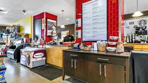 A fast-food restaurant interior with a counter, menu board, and various food items displayed. - Majestic Beach Towers 1-605 (Panama City Beach)
