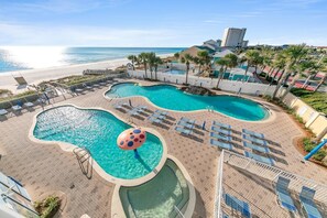 A resort with multiple swimming pools, a beach view, and a parking area. - Majestic Beach Towers 1-301 (Panama City Beach)