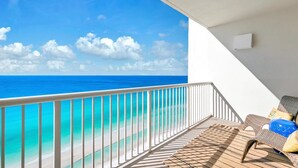 A balcony with a view of the ocean, a white railing, and a seating area with cushions. - Majestic Beach Towers 1-2109 (Panama City Beach)