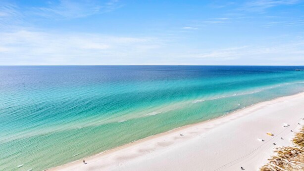 A beach with clear turquoise waters and a sandy shore. - Majestic Beach Towers 1-1803 (Panama City Beach)
