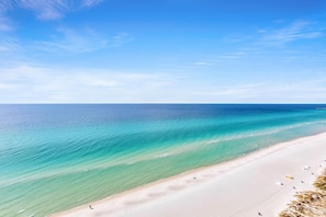 A beach with clear turquoise waters and a sandy shore. - Majestic Beach Towers 1-1803 (Panama City Beach)
