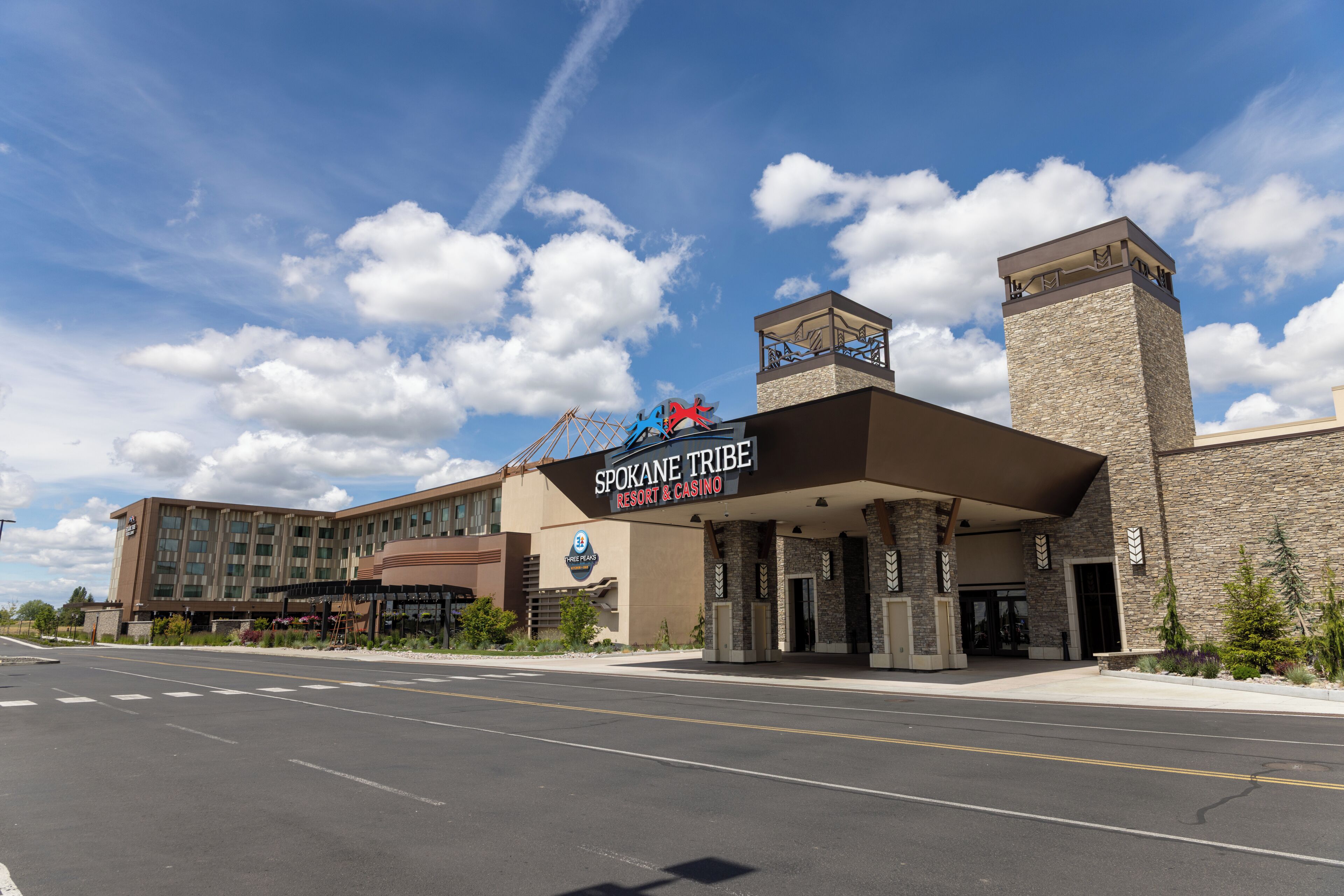 A Spokane Tribe Resort & Casino with a prominent entrance, a large building, and a clear sky.