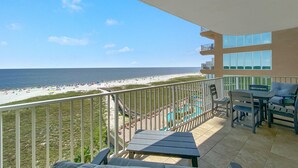 A balcony with a view of the beach and pool area. - Tidewater 609 (Orange Beach)