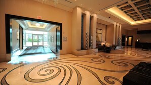 A spacious lobby with a marble floor, a glass entrance, and a ceiling with recessed lighting. - Amalz # 5, MGM Signature 2 Bedroom Balcony Suites ! (Las Vegas)