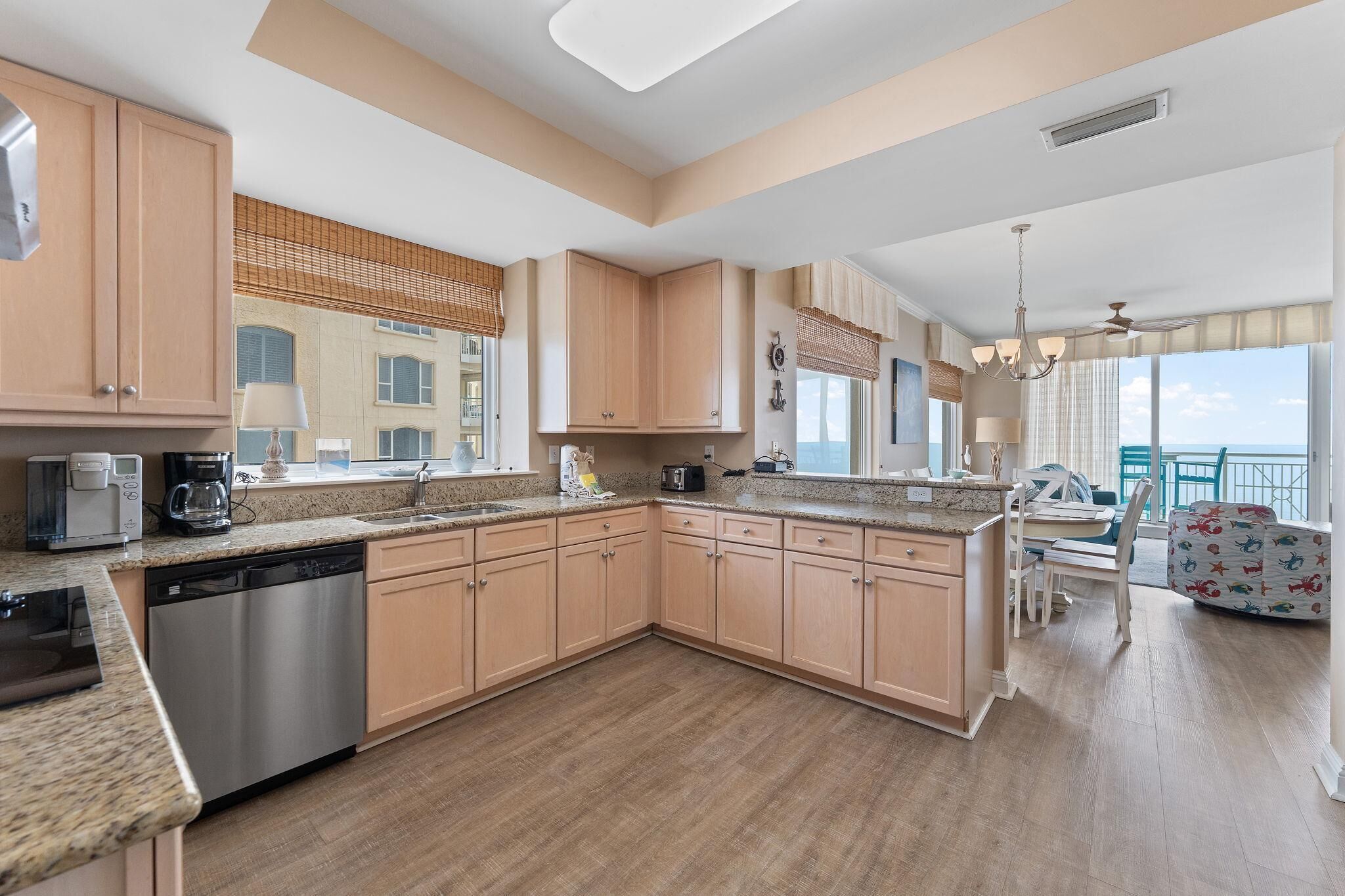 A modern kitchen with granite countertops, stainless steel appliances, and wooden cabinets.