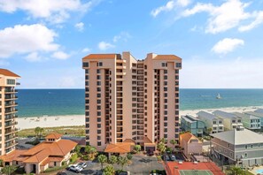 A high-rise hotel with multiple balconies, a beach view, and a parking area. - Seachase 905c (Orange Beach)