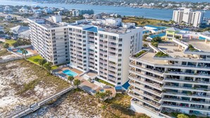A high-rise hotel with multiple balconies, a swimming pool, and a beach view. - Seaspray East 1023- Gulf Front (Pensacola)