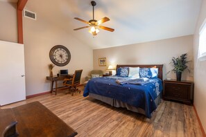 A bedroom with a bed, desk, chair, and a ceiling fan. - Wimberley Getaway with Private Pool and Fire Pit (Wimberley)