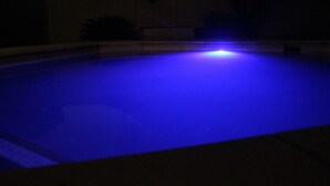 A swimming pool with a blue light.