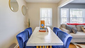 A dining area with a marble table, blue chairs, and a white ceiling fan. - Pet-Friendly Georgia Retreat w/ Fire Pit & Porch! (Forest Park)