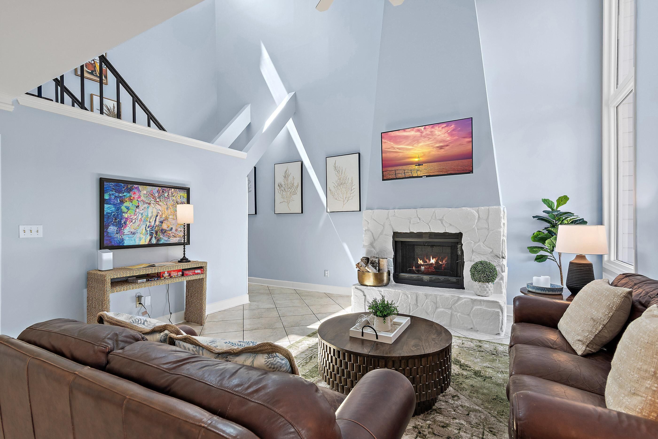 Una sala de estar con chimenea, un sofá, una mesa de centro y un televisor.