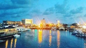 A waterfront cityscape with buildings, a marina, and a Ferris wheel. - Weathertree by the Sea off the Boardwalk Oceanview (Carolina Beach)