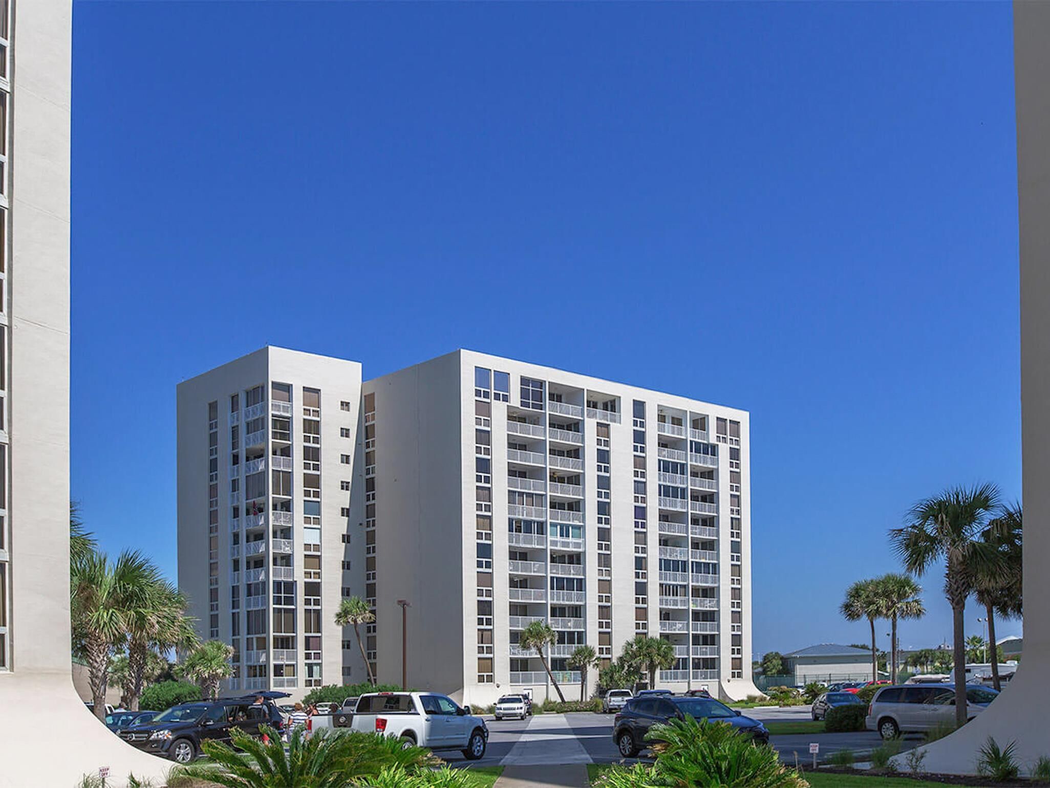 A multi-story hotel with a modern design, featuring balconies on each floor.