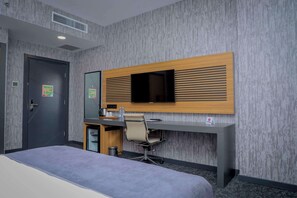 A hotel room with a bed, a desk with a chair, a television, and a door. - Best Western Premier Dj Hotel (Djibouti)