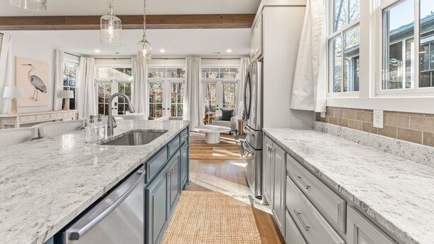 A modern kitchen with granite countertops, stainless steel appliances, and a large island. - Grange Getaway at Serenbe (Palmetto)