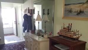 A room with a large mirror, a desk with a ship model, and a painting on the wall. - Cozy and beautiful Villa in trendy Fort Myers! Welcome to a home away form home! (Fort Myers)