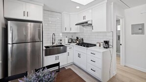 A modern kitchen with white cabinetry, a stainless steel refrigerator, a gas stove, and a built-in oven. - Cozy 1bd 1ba Sleeps 3 Close to Disney (Garden Grove)