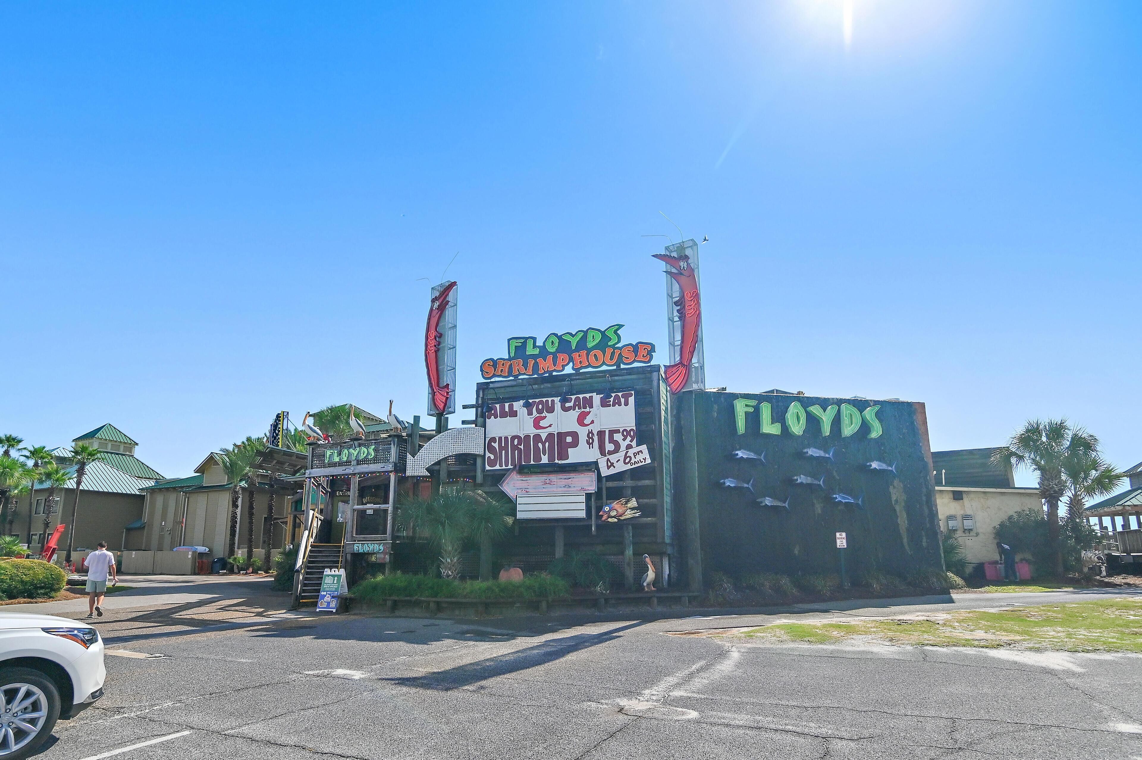 A building with a sign reading "Floyds Shrimphouse" and a large outdoor advertisement for shrimp at $15.