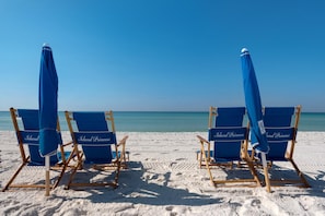 Relax in comfort with our beach chairs, each bearing the Island Princess logo, under the shade of matching umbrellas.
