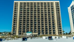 A high-rise hotel with multiple balconies, a beachside location, and a clear blue sky. - Sundestin 1808 (Destin)