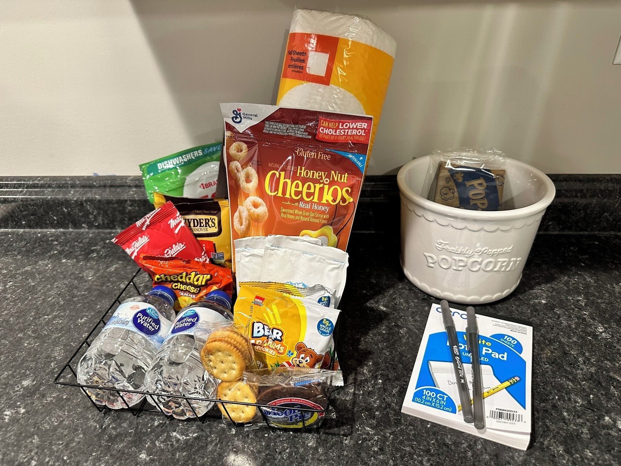 A kitchen counter with various food items and kitchen supplies.