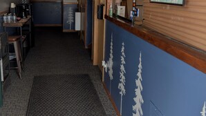 A hallway with a map, a coffee machine, and a sign indicating the restaurant is open. - The Hibernation Station (Sterling)