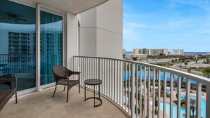 A balcony with a view of a pool and buildings. - Palms Resort #1813 Jr. 2BR (Destin)