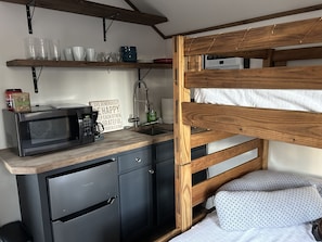 Fridge, microwave, coffee/tea maker, cookware/dishes/utensils