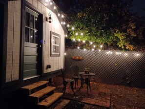 Cozy outdoor seating area with a room, complete with a small table and chairs.