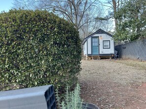 Cozy home with a small porch area and a well-maintained yard.