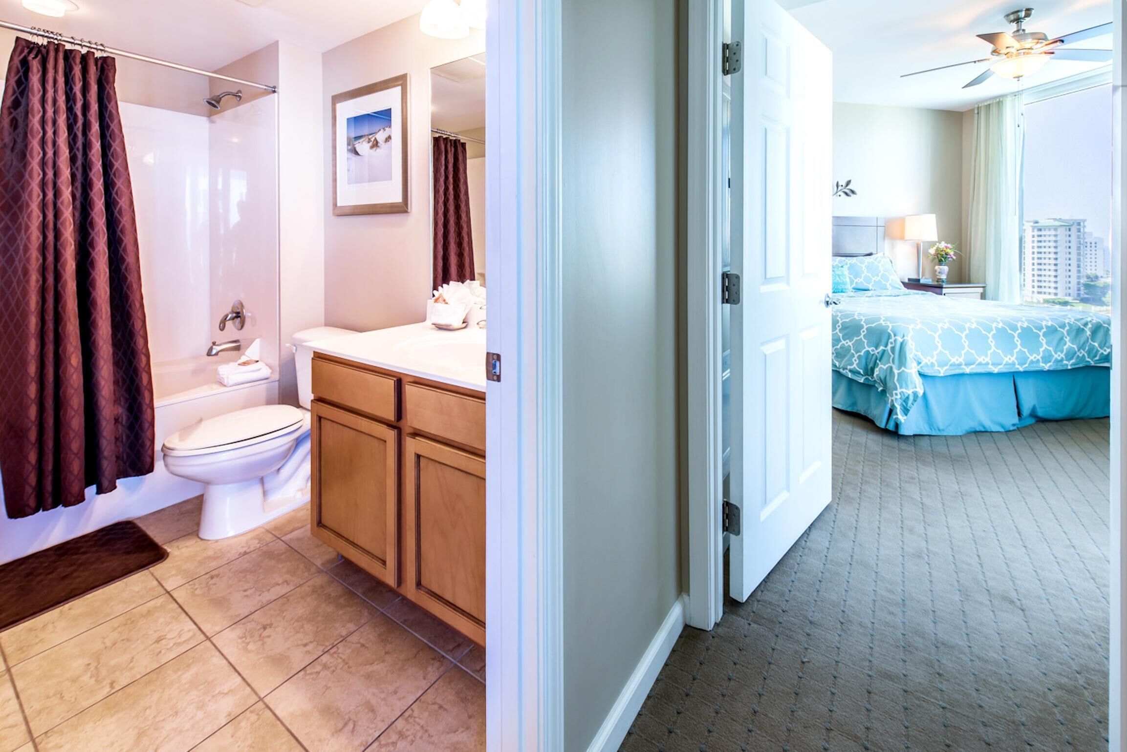 A hotel bathroom with a shower, toilet, and sink.