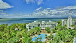 A large resort with multiple buildings, a swimming pool, and a view of the ocean. - Bahia 4417- The Bahia Beach House (Miramar Beach)