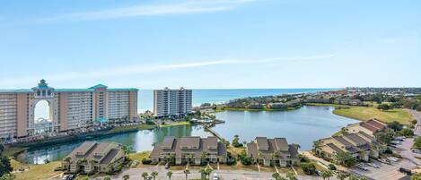 A resort with a large building, a swimming pool, and a lake.