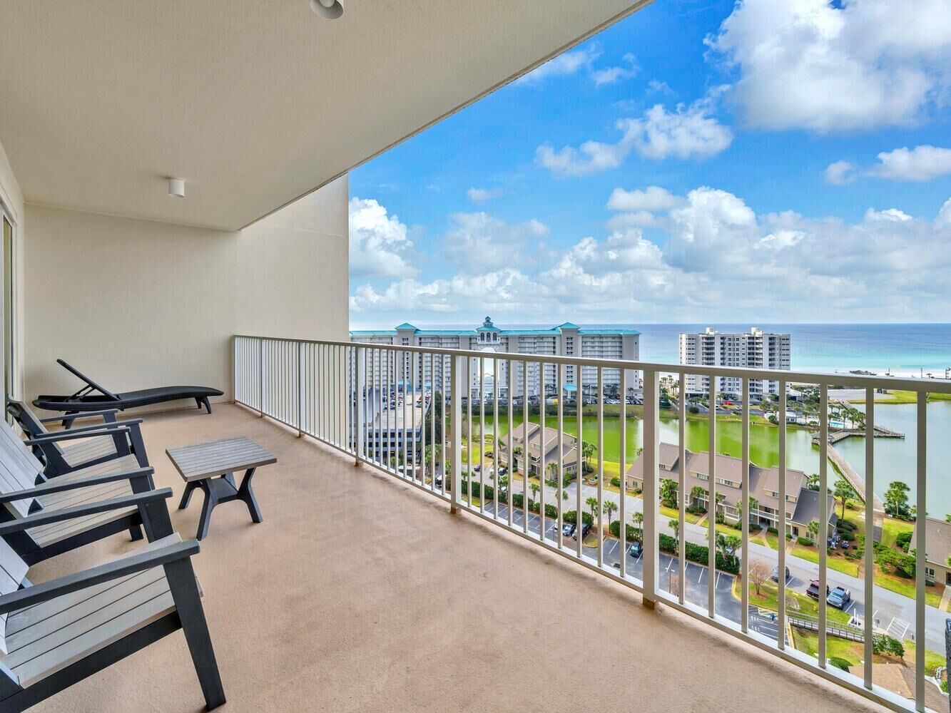 A balcony with a view of a marina and buildings.