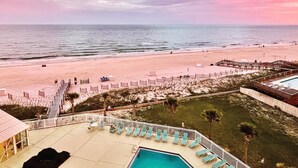 A beach resort with a pool area, lounge chairs, and a view of the ocean. - Perdido Sun 612 (Pensacola)
