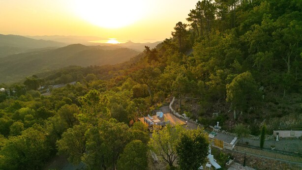 A resort with a pool, outdoor seating, and a scenic view of the surrounding hills. - Double Family Villa,12 people with Pool near Cannes (Fréjus)