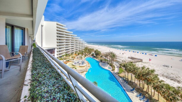 A hotel balcony with a view of a swimming pool, beach, and ocean. - Eden West 504 (Pensacola)