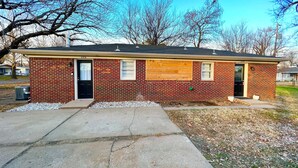 A single-story brick house with a black door, numbered 226. - Near Wichita Airport! Pet Friendly W/ Fenced Patio (Wichita)