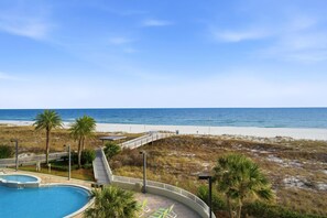 A pool area with a view of the beach and ocean. - Spanish Key 209 (Pensacola)