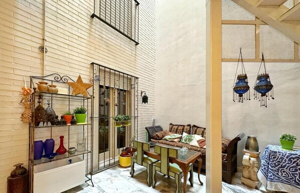 Cozy interior space with a high ceiling, exposed brick walls, and a comfortable seating area.
