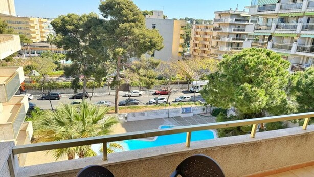 A balcony with a pool view, outdoor seating, and surrounding buildings. - Cozy Apartment with Pool, 300m from Levante Beach, Free WiFi, Near Port Aventura (Salou)