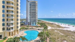 A high-rise hotel with a pool and beach view. - Beach Colony West 7A (Pensacola)