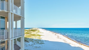 A beachfront hotel with multiple balconies overlooking the ocean. - Vista Del Mar 406 (Pensacola)