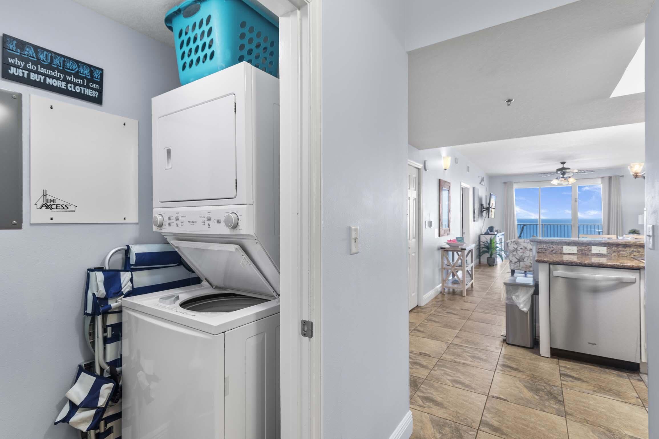 A laundry area with a washing machine, dryer, and a laundry basket.